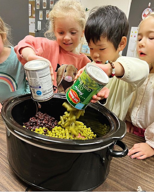 children making children making matza ball soup at preschool