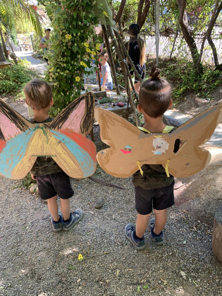 boys with giant butterfly art project back
