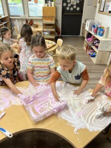 preschoolers playing with shaving cream