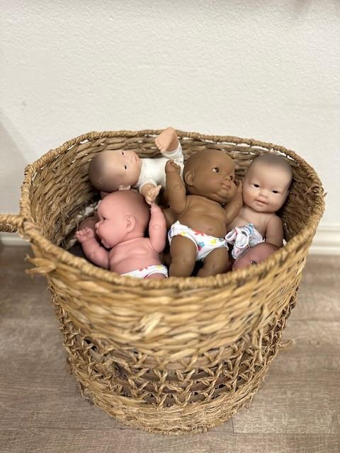 basket of toy dolls