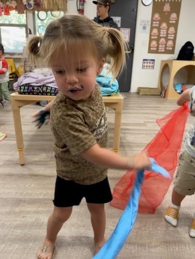 girl at preschool swing ribbon around
