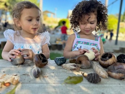 girls playing with shells at preschool