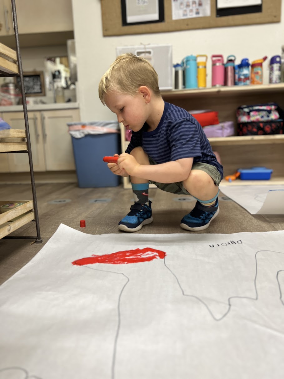 toddler at preschool making art