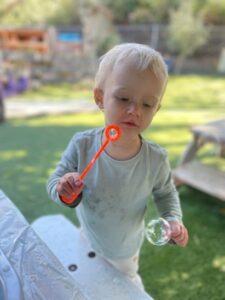 boy with bubbles outside