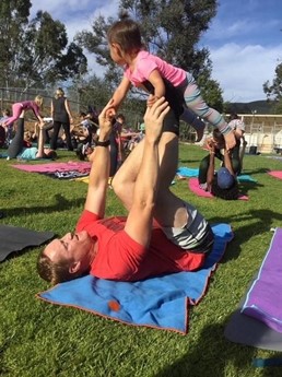 dad with child for family yoga