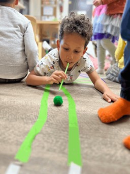 child playing with strawmaze at prechool