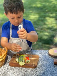 boy preparing farm to table food at preschool