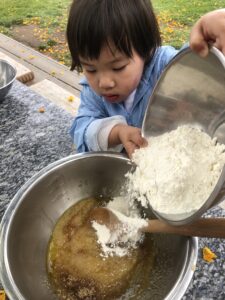 making zucchini muffins at preschool