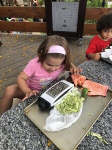 child with zucchini at preschool