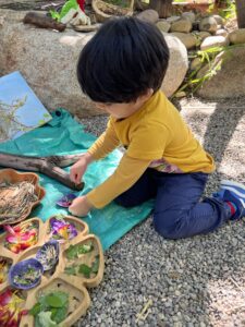 boy enjoying learning outside at preschool