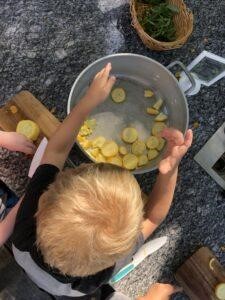 child making squash pizza at preschool