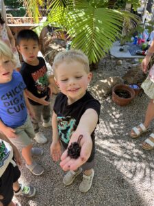 preschool boy showing off what he found outside