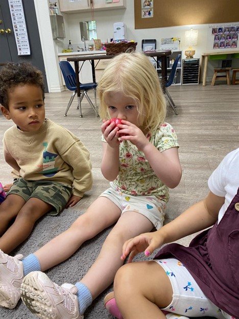 preschool girl with apple