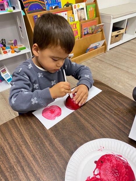 preschooler tracing apple